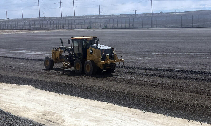 Road work being leveled and smoothed.